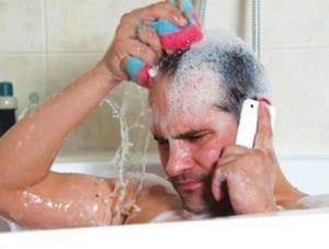 Homme dans son bain qui utilise un smartphone
