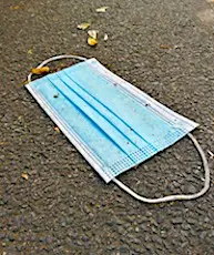 Un masque chirurgical jeté par terre. Le recyclage de masques usagés, fait par la société Plaxtil, permet ensuite de fabriquer d'autres objets en plastique.