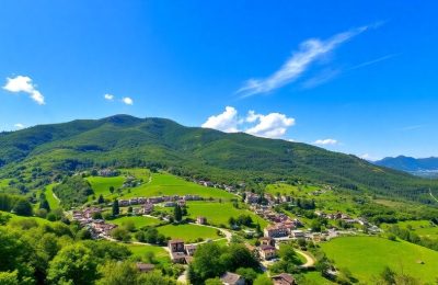 Paysage alpin verdoyant avec villages et ciel bleu.