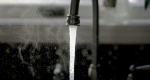 De l’eau coule d’un robinet dans un logement