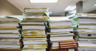 Dossier de surendettement : piles de documents et de classeurs